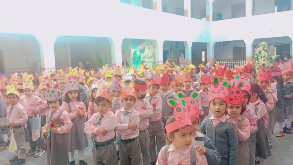 Students in uniform wearing animal character hats during a creative school activity at Ashraf Islamia Model Public School